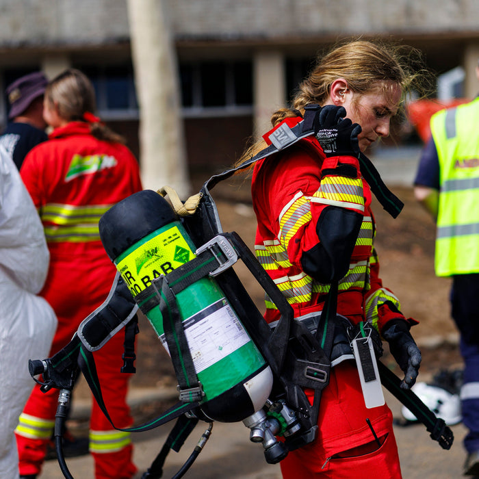 Rescuer in red carrying light weight ba set donning